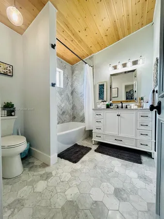 a bathroom with a sink a toilet and mirror