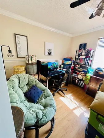 a living room with furniture and a bookshelf