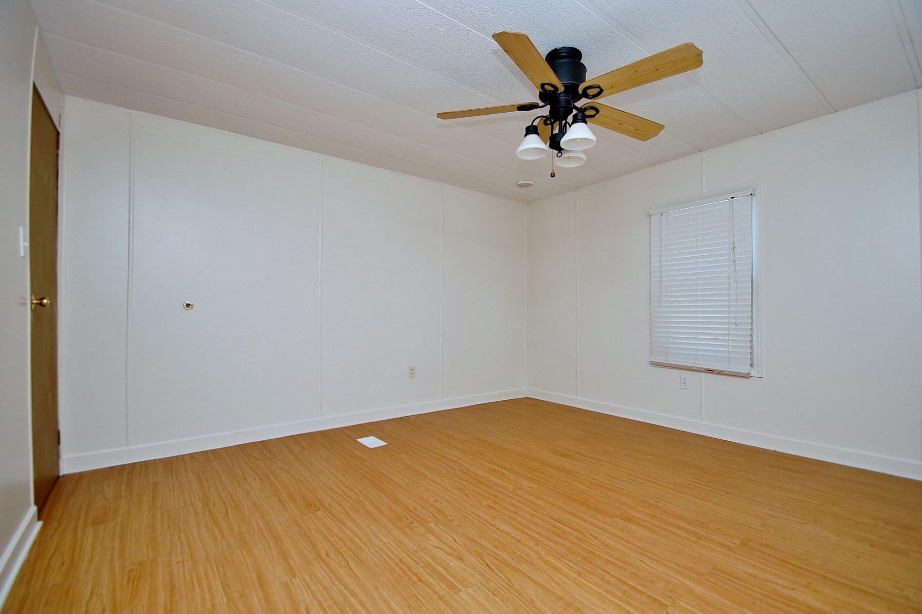 164 Tabernacle Road Penhook, VA 24137 - Photo 19 of 46 an empty room with wooden floor and ceiling fan