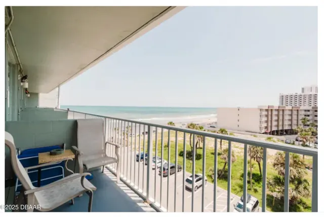 a view of a tables and chairs under an umbrella in patio