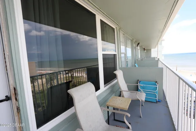 a kitchen with granite countertop cabinets a refrigerator and a sink