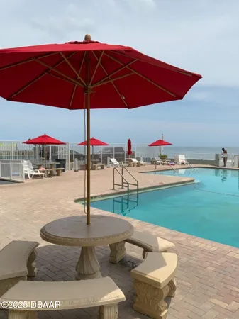 a view of a table and chairs under an umbrella
