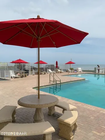 a view of a table and chairs under an umbrella