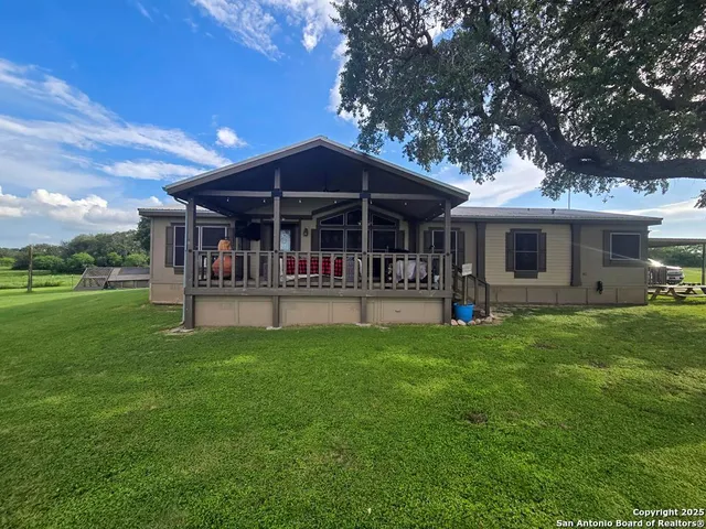 a view of a house with a yard porch and sitting area