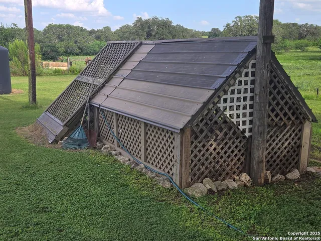 a view of a backyard with wooden fence
