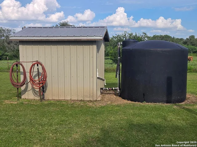 a backyard of a house with bicycles parked and a swing