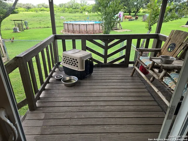 a view of deck with furniture and garden