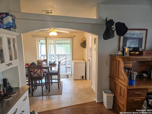 a view of a dining room with furniture and chandelier
