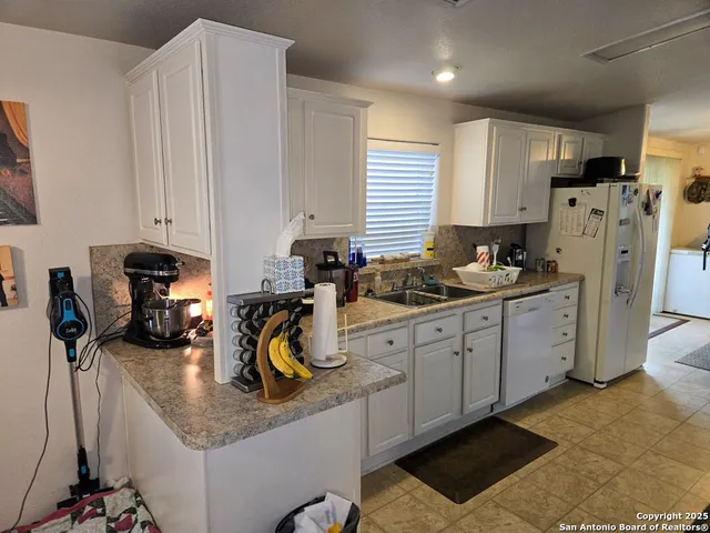 a kitchen with refrigerator and window