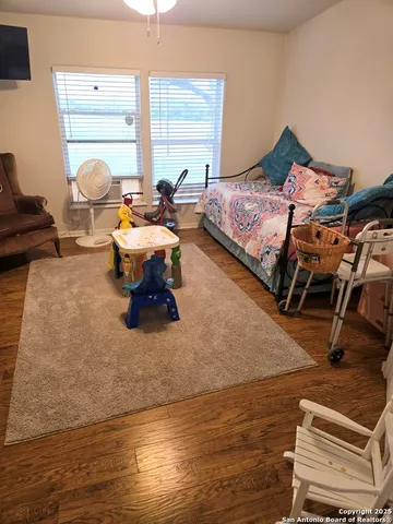 a bedroom with furniture and a window