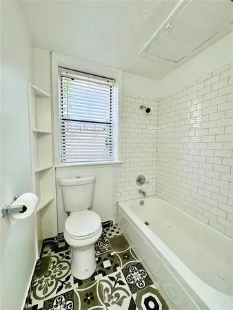 a bathroom with a sink toilet and mirror