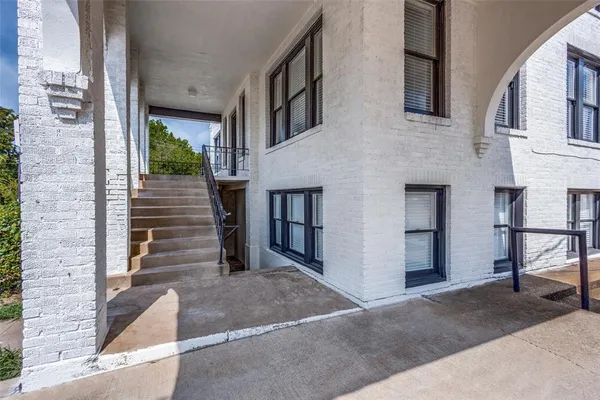 a view of a brick house with many windows