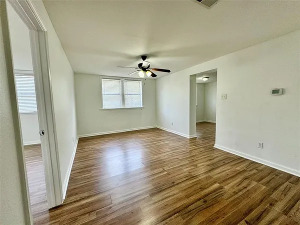 a view of a kitchen with a sink and a refrigerator