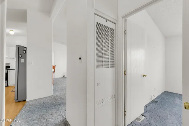 a kitchen with stainless steel appliances kitchen island granite countertop a refrigerator a stove a sink and white cabinets