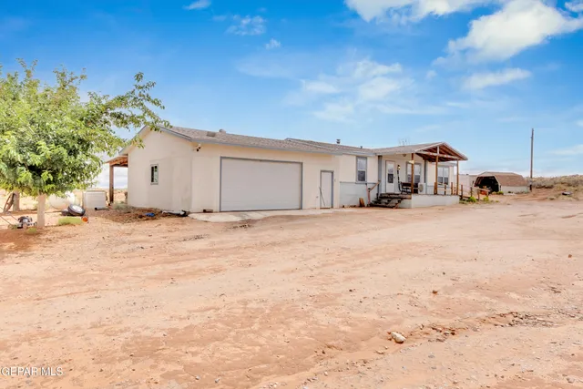 a view of white house with a snow on the road
