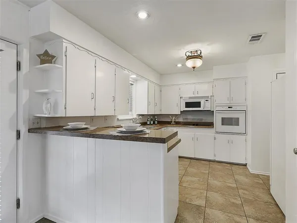 a kitchen with stainless steel appliances cabinets a sink and a stove