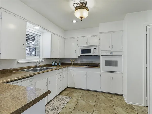 a kitchen with stainless steel appliances granite countertop a sink and cabinets