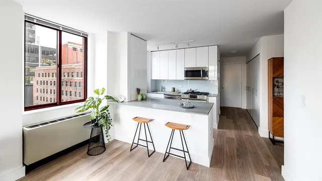 a kitchen with sink table and chairs
