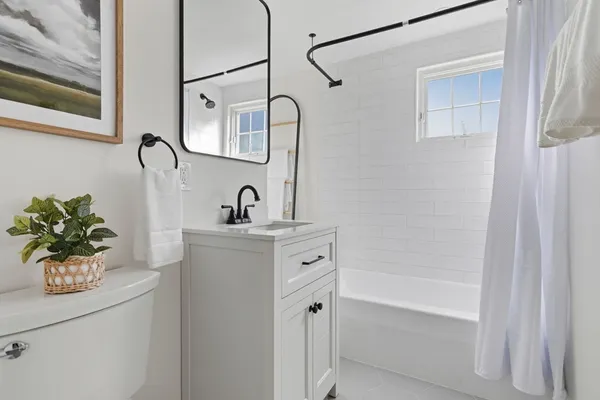 a bathroom with a sink a mirror and a bathtub