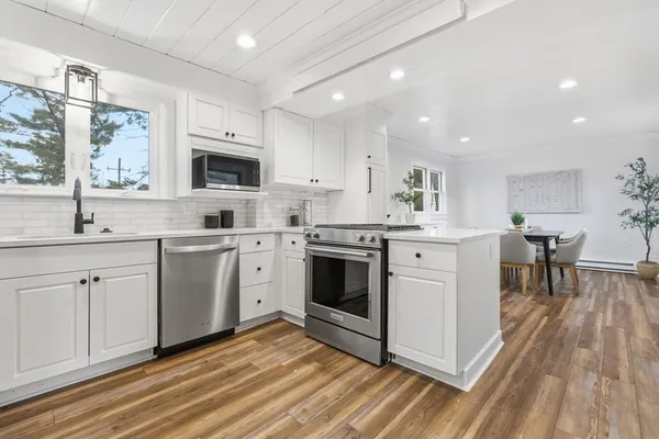 a kitchen with a stove a sink and a microwave