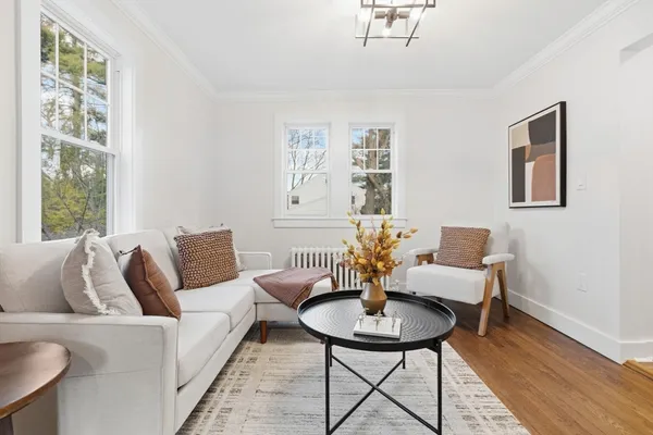 a living room with furniture and wooden floor