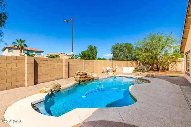 a view of a backyard with table and chairs