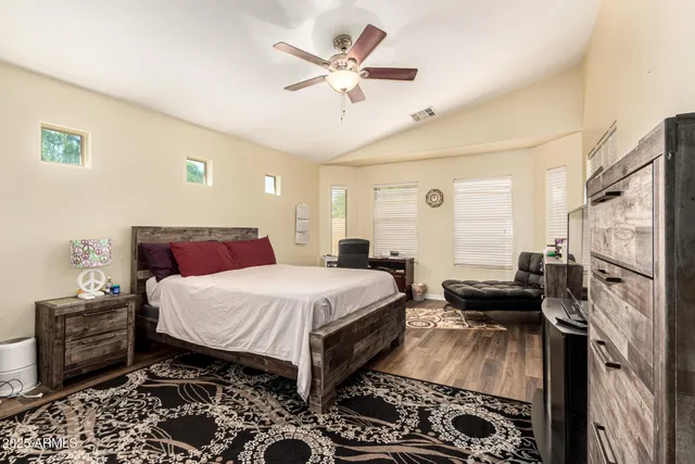 a bedroom with a bed and a chandelier