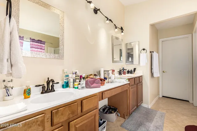 a bathroom with a sink double vanity and a mirror