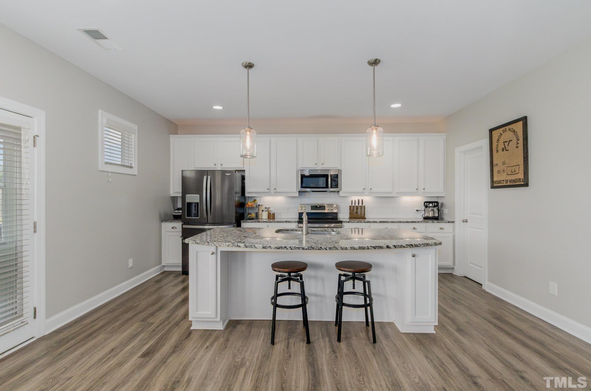 428 Seabring Lane Raleigh, NC 27603 - Photo 13 of 40 Kitchen with walk in pantry and new stove and dishwasher