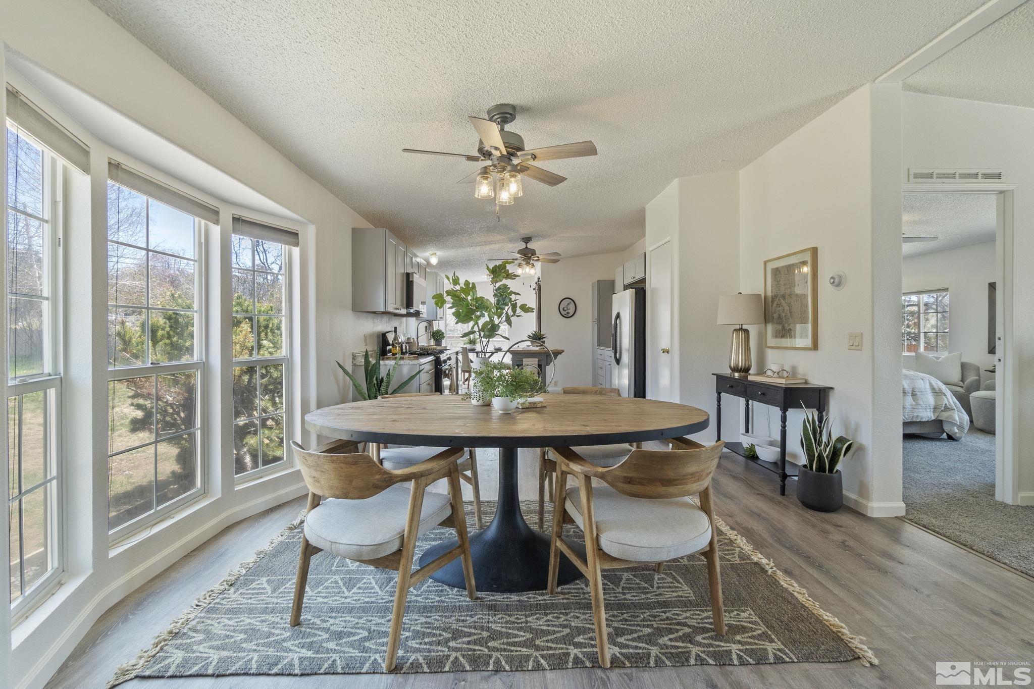15015 Kivett Lane Reno, NV 89521 - Photo 11 of 37 a dining room with furniture window and wooden floor