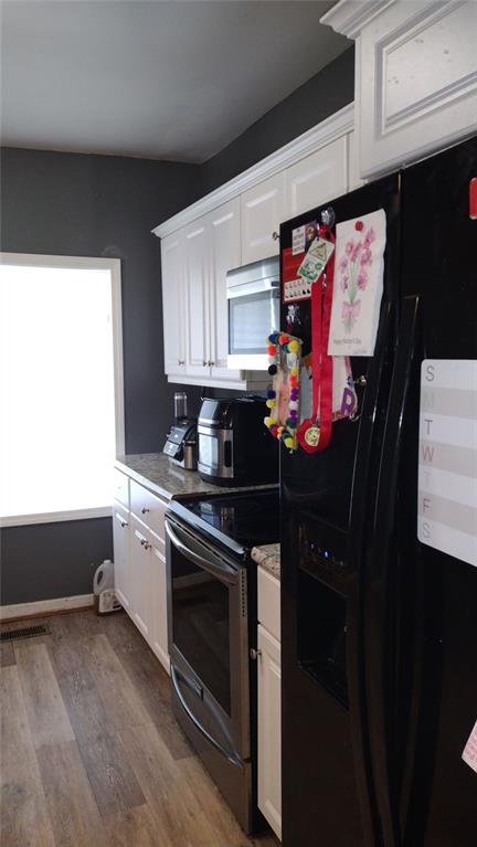 136 Hill Street Commerce, GA 30529 - Photo 13 of 27 a kitchen with stainless steel appliances granite countertop a stove a sink and a microwave