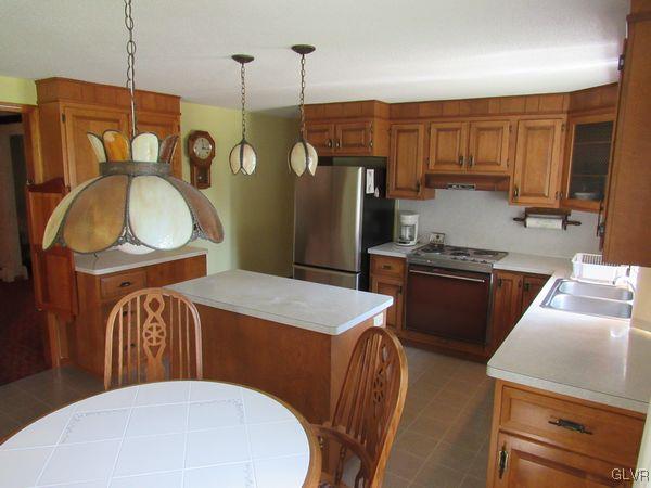 741 South Delps Road Bath, PA 18014 - Photo 14 of 45 a kitchen with stainless steel appliances granite countertop a sink a stove and a refrigerator