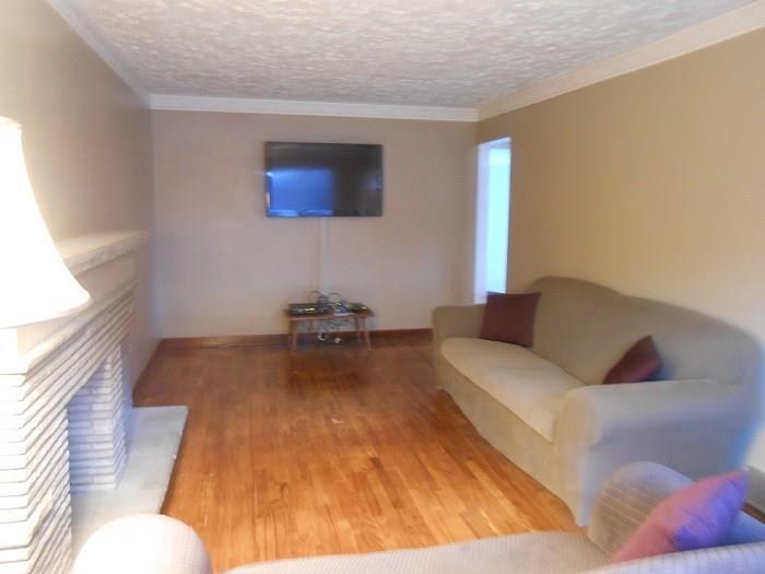 10 Ridge Road Braddock Hills, PA 15221 - Photo 2 of 18 To the left as you enter the front door, is the formal Living Room which boasts hardwood floors, and stone fireplace. Enjoy watching your favorite TV show on the 46" flat screen TV mounted on the far wall (it will stay).