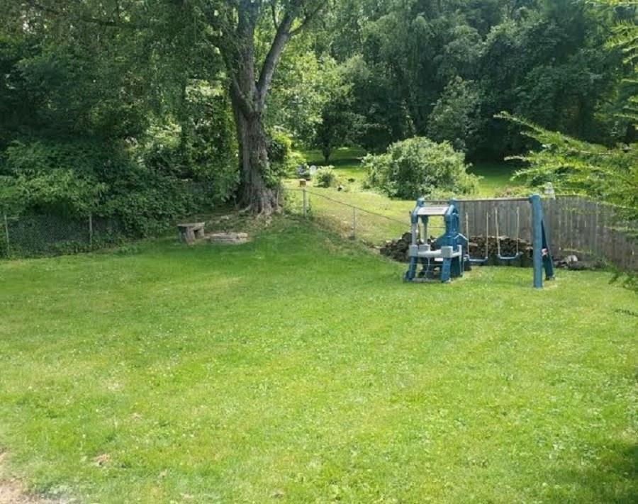 10 Ridge Road Braddock Hills, PA 15221 - Photo 17 of 18 Mostly level, fenced backyard provides plenty of space for gardens, outdoor recreational equipment (swing set shown here can stay); and/or an above ground pool. *Not seen here (photos coming soon) is a paved parking area beneath the Family Room/den addition which could be used as patio or additional parking area.