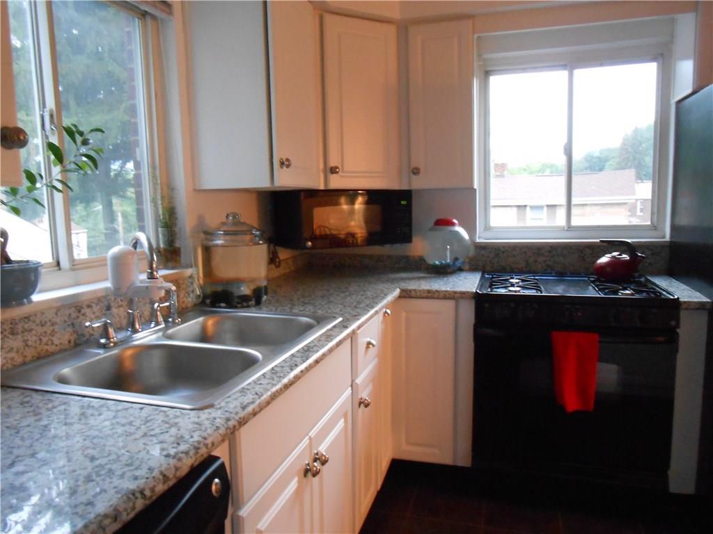 10 Ridge Road Braddock Hills, PA 15221 - Photo 8 of 18 The updated kitchen boasts granite counter tops, tile floor, and full compliment of appliances. Newer windows in this room (and most other rooms) allows for the warm/welcoming of nature's sunlight indoors!