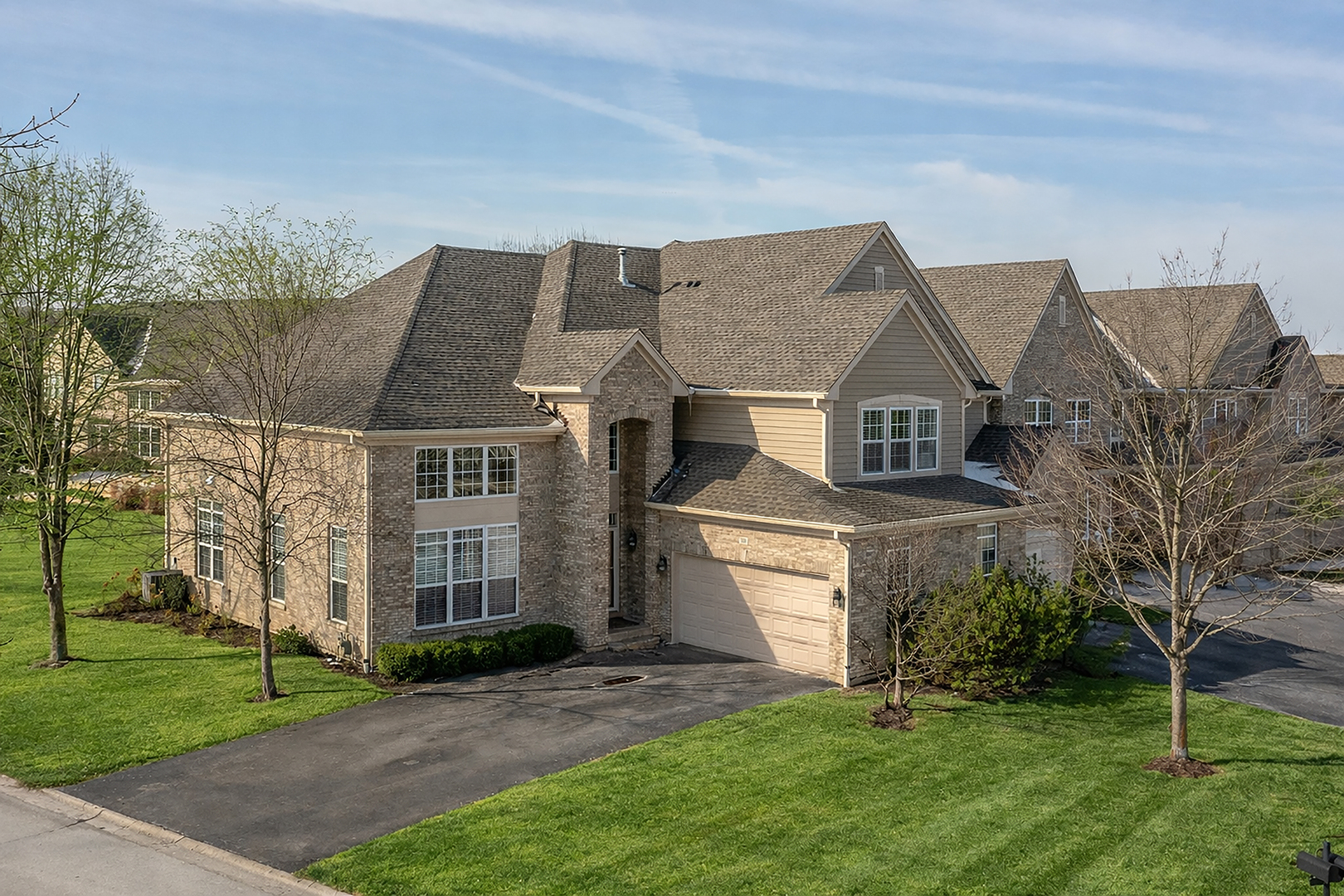 500 Stone Canyon Circle Inverness, IL 60010 - Photo 1 of 33 a front view of a house with a garden and plants