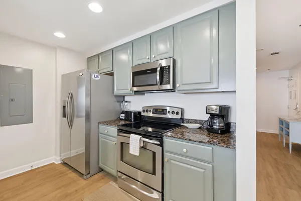 a bathroom with a granite countertop sink a large mirror and a shower