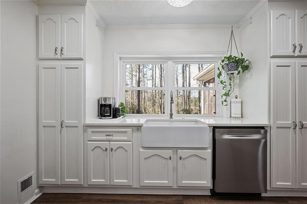 4505 Cochran Mill Road Fairburn, GA 30213 - Photo 14 of 36 a kitchen with white cabinets and a window