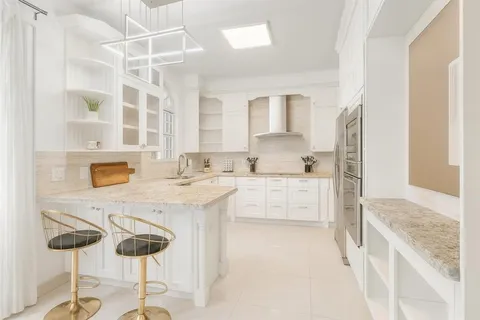 a kitchen with stainless steel appliances kitchen island granite countertop a sink and cabinets