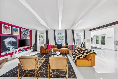 a living room with furniture a flat screen tv and a large window