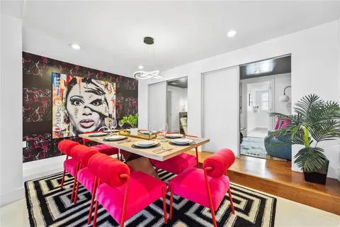 a view of a dining room with furniture and a chandelier