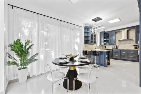 a kitchen with a table and chairs in it