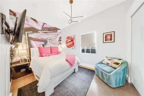 a bedroom with a bed and a flat screen tv