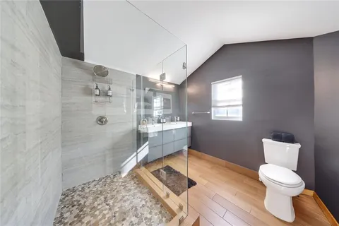 a bathroom with a double vanity sink mirror and shower