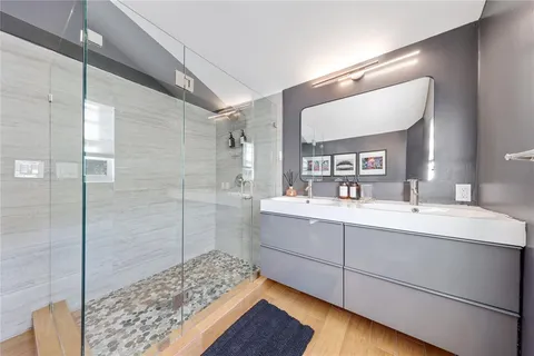 a bathroom with a sink a toilet and a mirror