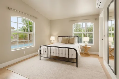 a spacious bedroom with a bed and a window
