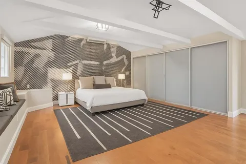 a bedroom with a bed and a mirror