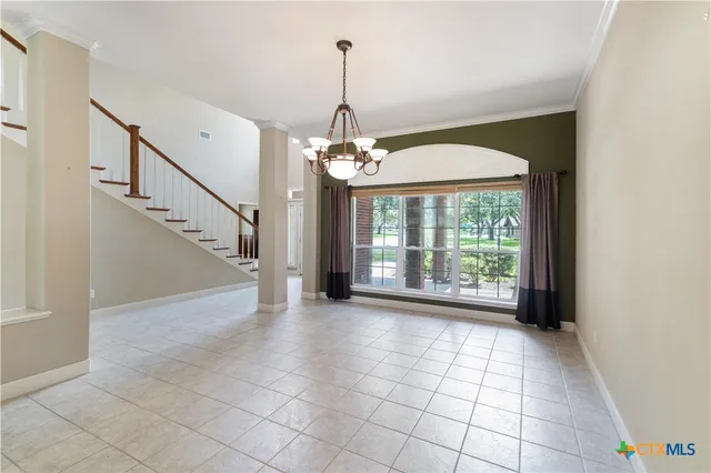 a view of a room with window wooden floor and front door