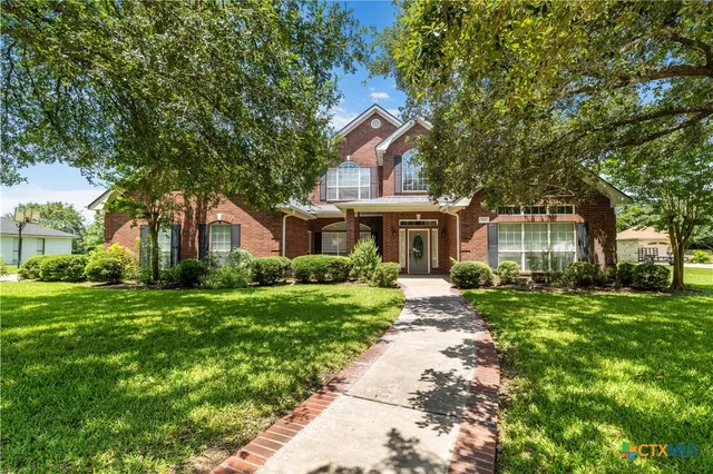 a front view of a house with a yard and porch