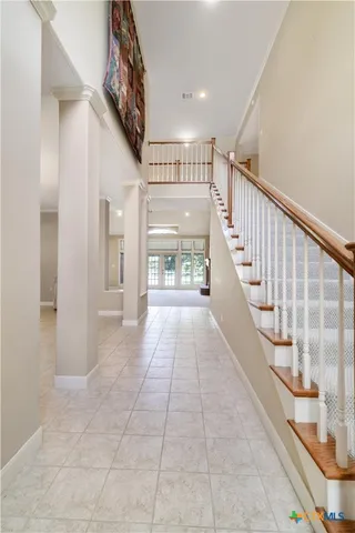 a view of entryway and hall with a front door